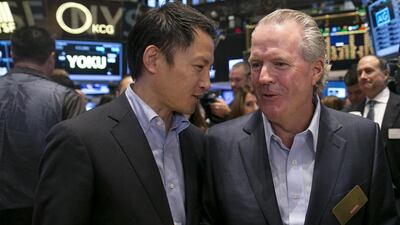 JP Morgan Vice Chairman James Lee, right, attends the Alibaba initial public offering at the New York Stock Exchange. JP Morgan was one of the bookrunners of the IPO. Brendan McDermid / Reuters