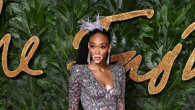 Model Winnie Harlow goes for ultra feminine in this feather-trimmed grey gown. Getty