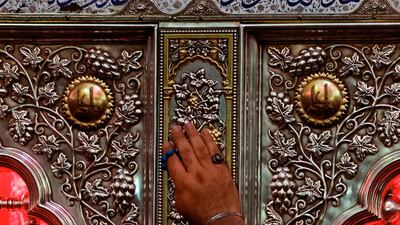 A pilgrim touches the shrine