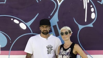 Sya, left, and Bow stand against the wall in their home that' sopen to all artists. Jaime Puebla / The National