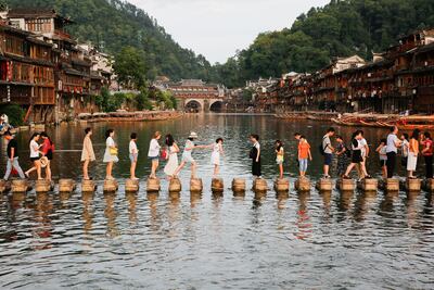 Stone piers crossing the Tuojiang River in the ancient town of Fenghuang in Xiangxi, in China's mountainous central Hunan province. The old town boasts impressive Ming and Qing dynasty architecture. AFP Photo / STR / China OUT