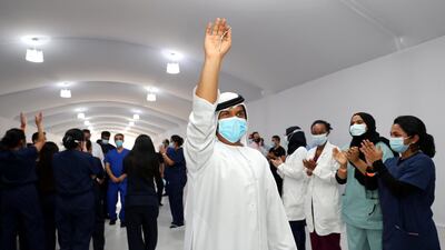 The keys to Dubai Parks and Resorts field hospital are held up in celebration of its closure. Chris Whiteoak / The National