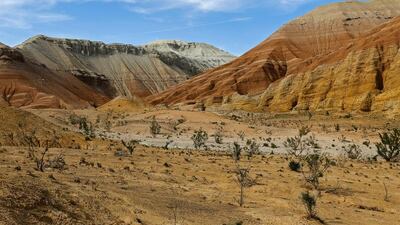 An airplane leaves a trail over the Aktau mountain range in Altyn-Emel national park. Shamil Zhumatov / Reuters