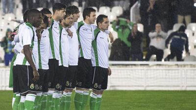Racing Santander players stand in a line and refuse to play at the start of their King's Cup quarter-final second leg against Real Sociedad in Santander, northern Spain, January 30, 2014. The King's Cup descended into farce when Racing Santander's players, protesting over unpaid wages, refused to challenge for the ball after their quarter-final second leg at home to Real Sociedad kicked off. The third-tier team announced they would boycott the game unless club president Angel Lavin and the board resigned and they formed a line on the centre circle immediately after the match at the Sardinero began. Nacho Cubero / Reuters