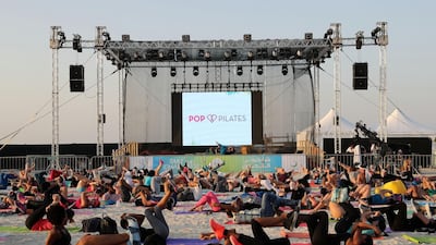 Participants in last year's Dubai Fitness Challenge attend a free fitness session by Cassey Ho, fitness influencer and American pilates star at Kite Beach in Dubai. Chris Whiteoak / The National