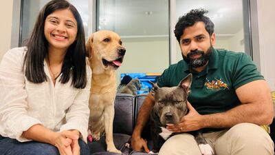 Pooja Singh and her husband with their two dogs, a labrador called Buddy and an American Bully called Stella. Photo: Pooja Singh