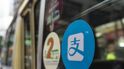 A sign for digital payment service Alipay by Ant Group, an affiliate of Alibaba Group, is displayed on a public bus in Hong Kong. Billionaire Jack Ma's Ant Group is poised to pull off what could be the biggest initial public offering ever by simultaneously listing in Hong Kong and Shanghai. Bloomberg