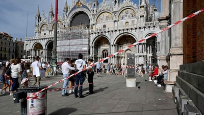 A cordoned area at the bottom of the bell tower at St Mark's in Venice after the wind knocked pieces from the roof on Thursday. AFP