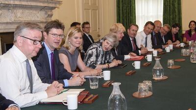 British prime minister Theresa May, 4th from the left, holding the first cabinet meeting of her new team inside 10 Downing Street, in London, on June 12, 2017 after last week's general election where her Conservative Party lost the majority in parliament in a stinging defeat. Leon Neal/Pool via AP