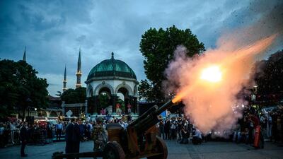 Turkish soldiers fire a military cannon to mark fasting break time at the Blue mosque square in Istanbul. Ozan Kose / AFP