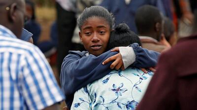A student embraces her parent following a fire that burnt down one dormitory of Moi Girls school in Nairobi, Kenya on September 2, 2017. Baz Ratner / Reuters