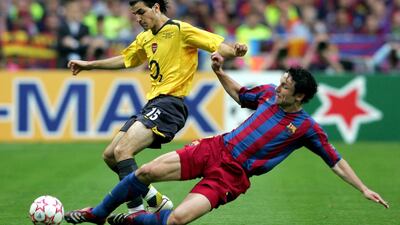 Francesc Fabregas is challenged by Mark Van Bommel. Getty