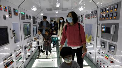 Visitors walk inside a model of the core module of the Tianhe space station at an exhibition featuring the development of China's space exploration on the country's Space Day at China Science and Technology Museum in Beijing. Reuters