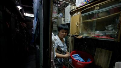 Their chipboard and corrugated iron home is one among a dark warren of around 10 shacks on top of a 10-storey building in the working-class Sham Shui Po neighbourhood. Anthony Wallace/AFP Photo