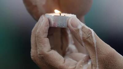 A Catholic faithful holds a candle during an open-air Mass led by Pope Francis at Rizal Park in Manila. Huge crowds converged on a Manila park on Sunday to see Pope Francis wrap up his Asian trip with an outdoor Mass expected to draw one of the largest crowds in Philippine history. Cheryl Ravelo / Reuters