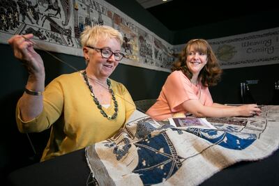 Tapestry experts work on the 77-metre-long tapestry, currently on display at the Ulster Museum - Game of Thrones Tapestry Exhibition.