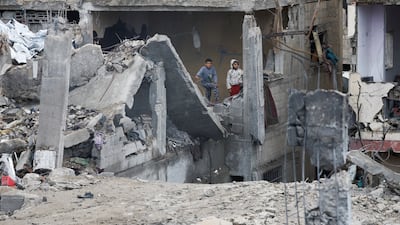 Palestinian children stand at the site of an Israeli strike on a house in the central Gaza Strip on January 9, 2026. Reuters