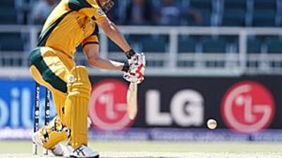Australia's Mitchell Johnson hits the West Indies' bowler Daren Sammy for six during their Champions Trophy match at the Wanderers.