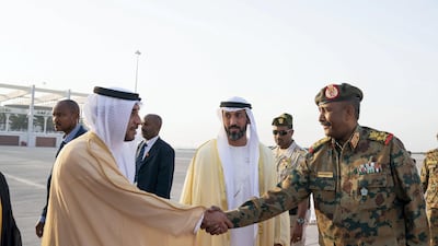 Humaid bin Saeed Al Neyadi, Deputy Director of the Office of the UAE Minister of Presidential Affairs (left) greets Lieutenant General Abdel Fattah Al Burhan Abdelrahman, Head of Transitional Military Council of Sudan, at the Presidential Airport. Seen with Mohamed Mubarak Al Mazrouei, Undersecretary of the Crown Prince Court of Abu Dhabi (centre). Mohamed Al Hammadi / Ministry of Presidential Affairs