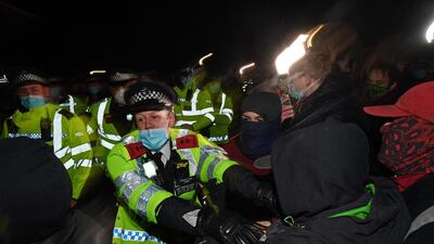 Police scuffle with people gathering at Clapham Common bandstand in London. AFP