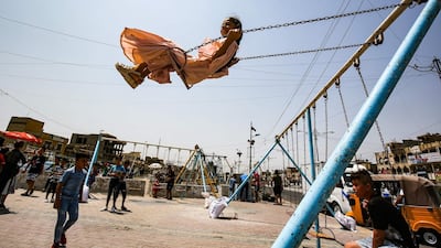 A girl rides on a swing at in the Iraqi capital Baghdad's eastern suburb of Sadr City, as people celebrate the Muslim religious festival of Eid al-Adha. AFP
