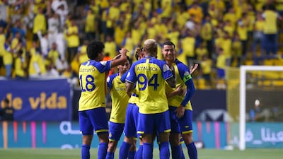 Al Nassr players celebrate after scoring during the Saudi Pro League football match against Al Khaleej.