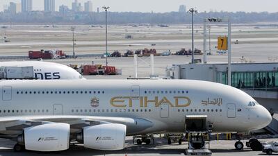 An Etihad plane stands parked at a gate at JFK International Airport in New York, U.S., March 21, 2017. REUTERS/Lucas Jackson - RC148A729010