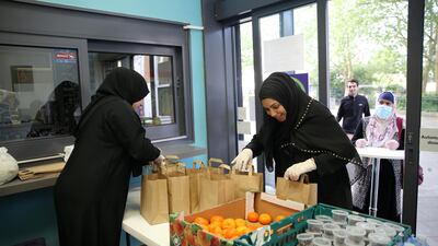 Volunteers Samira and Fateha Miah organise takeaway iftar meal from the Queen's Crescent Community Centre at a pop-up facility open for both Muslims and non-Muslims as part of their Iftar for All project in north London, May 09, 2020. Getty Images