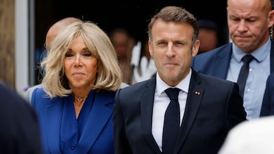 Mr Macron and his wife Brigitte. AFP