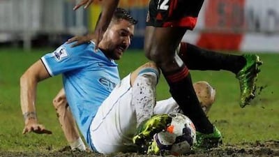Manchester City's Javi Garcia, left, fights for the ball.