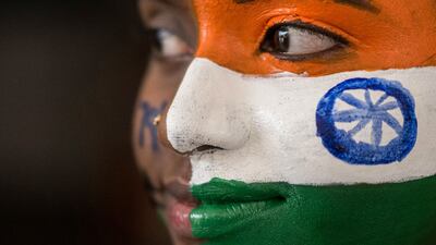 A college student paints her face in the colours of the Indian national flag on the eve of Independence Day in Chennai. AFP