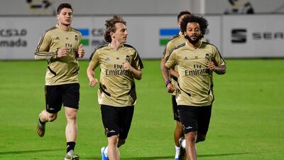 Real Madrid's Croatian midfielder Luka Modric (2nd-L) and Real Madrid's Brazilian defender Marcelo (R) warm up during a training session. AFP