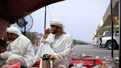 Guests drink Gahwa, or Arabic coffee made with coffee beans and cardamon at Abdullah Al Yalyle's home Majlis in Wadi Al Tuwa. Ras Al Khaimah, United Arab Emirates.