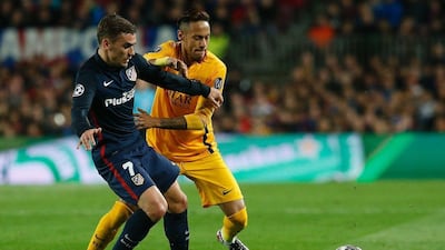 Barcelona's Neymar and Atletico Madrid's Antoine Griezmann battle for the ball during their Champions League contest on Tuesday night. Pau Barrena / AFP / April 5, 2016