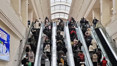People wearing face masks ride escalators inside Hankou Railway Station in Wuhan, China. Getty Images