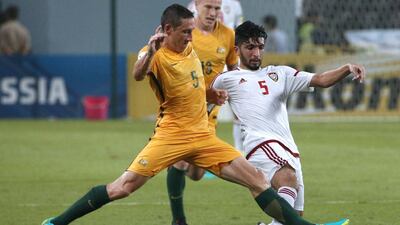 Mark Milligan, left, in action against UAE midfielder Amer Abdulrahman during Australia's 1-0 victory in Abu Dhabi. Karim Sahib / AFP