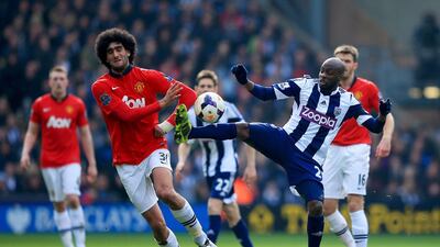 Marouane Fellaini of Manchester United battles with Youssuf Mulumbu of West Bromwich Albion during their Premier League match at The Hawthorns on March 8, 2014 in West Bromwich, England. Richard Heathcote/Getty Images