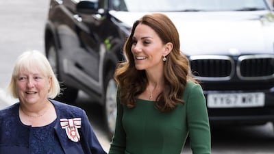 The Duchess of Cambridge wears a green Emilia Wickstead dress with a a Mulberry Amberley clutch bag, Gianvito Rossi Praline 85 Pumps and Kiki McDonough jewellery to open the Anna Freud Centre on May 1. EPA