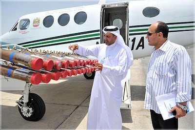 Meteorology centre officials pictured inspecting flares attached to a plane's wing. Cloud seeding operations in the UAE can boost rainfall from clouds by about a third. Courtesy National Centre for Meteorology and Seismology