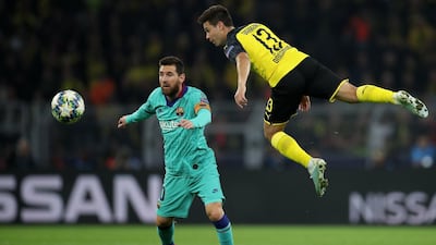 Dortmund's Raphael Guerreiro in action against Barcelona's Lionel Messi. EPA