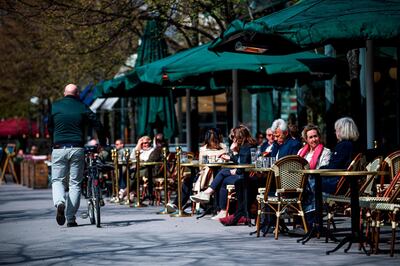 People sit in a restaurant in Stockholm on May 8, 2020, amid the coronavirus pandemic. AFP