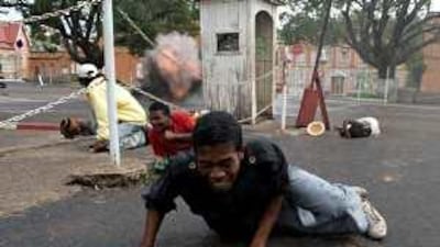 People come under fire near the offices of Marc Ravalomanana, Madagascar's president, in Antananarivo.