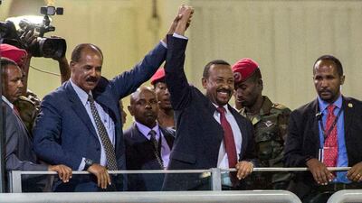 Eritrean President Isaias Afwerki, left, and Ethiopia's Prime Minister Abiy Ahmed hold hands as they wave to crowds in Addis Ababa on July 15, 2018. AP Photo