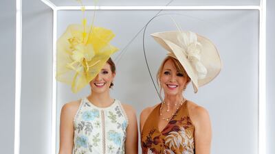 Women show off their hats and patterned dresses. Pawan Singh / The National