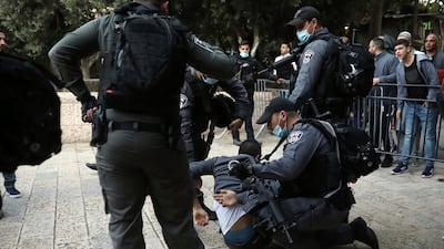 Israeli police officers detain a Palestinian man who tried to break through a security barrier to enter the closed Al Aqsa Mosque compound, which remains shut to prevent the spread of coronavirus, in Jerusalem, on Sunday, May 24, 2020. AP