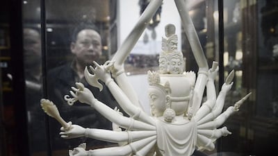 This picture taken on February 20, 2013 shows a Chinese man looking at an ivory Buddha carving at a shop in Beijing. Wang Zhao/AFP Photo