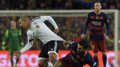 Barcelona midfielder Arda Turan, right, vies with Valencia midfielder Sofiane Feghouli. Lluis Gene / AFP