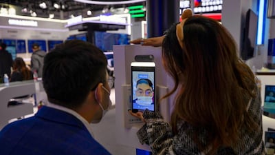 A man tries a new facial recognition system that can be used with masks at a booth operated by Chinese technology company Baidu at the World Internet Conference in Wuzhen, Zheijang. Smart Dubai hopes to roll out facial recognition to authenticate transactions. EPA