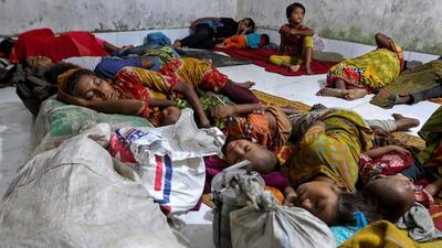 Bangladeshi villagers sleep in a cyclone shelter following an evacuation by authorities in the coastal villages of the Cox's Bazar district on May 29, 2017 as Cyclone Mora gradually approaches towards the coastline. AFP