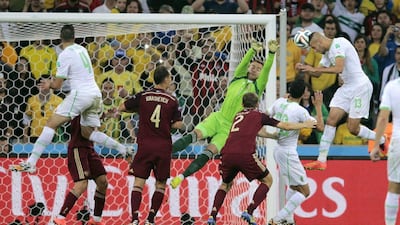 Islam Slimani, right, of Algeria heads in the equaliser against Russia to make it 1-1 on Thursday in their 2014 World Cup Group H match in Curitiba, Brazil. Ivan Sekretarev / AP
